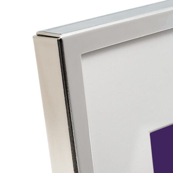 Silver photo frame corner with white mat.