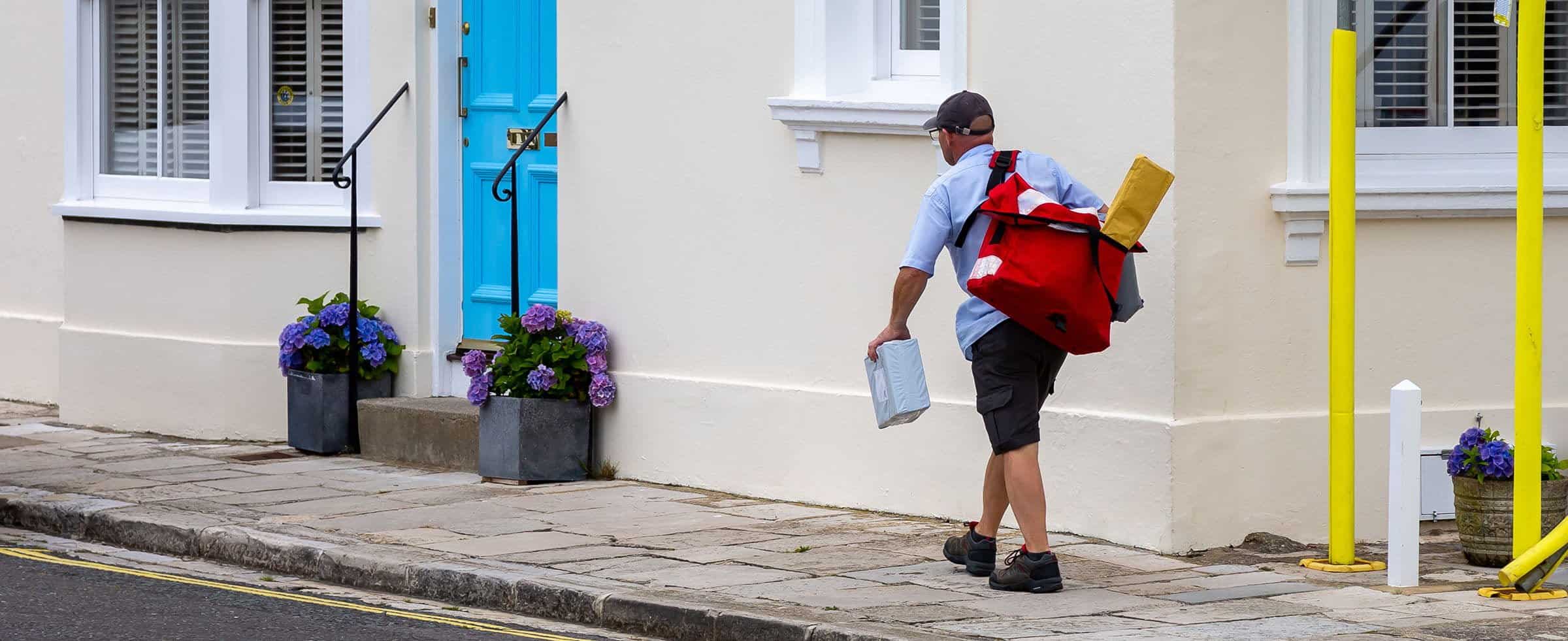Postman making deliveries on foot.