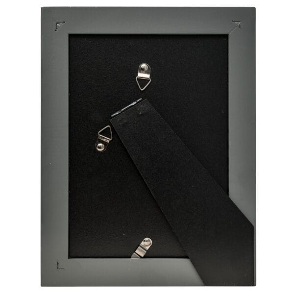 Back of a black picture frame with stand.