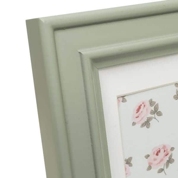 Green picture frame with floral pattern.