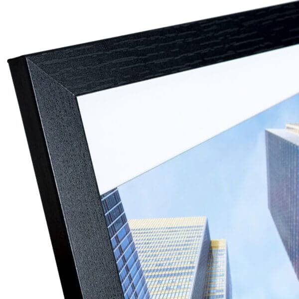 Close-up of modern black picture frame and skyscraper photo.